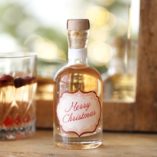 100ml Merry Christmas Spiced Gin in front of mirror with glass behind