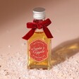 40ml Santa's Tipple Christmas Whisky on top of fake snow against neutral coloured background