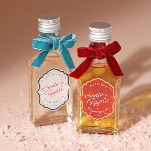 40ml Santa's Tipple Christmas Whisky with Christmas spiced gin on top of fake snow with neutral coloured background