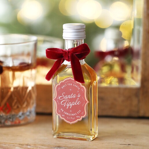 40ml Santa's Tipple Christmas Whisky in lifestyle shot on top of wooden counter with glass in background