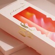 Close up of candles in packaging of Pink Stories Peach Melba Dip Dye Swirl Candles