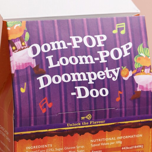 Piece of text underneath tab of Popcorn Shed Chocolate Orange Gourmet Popcorn packaging