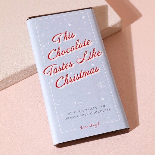 Tastes Like Christmas Almond Raisin and Orange Milk Chocolate Bar on neutral coloured background