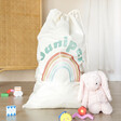 Personalised Rainbow Large Drawstring Storage Sack with jellycat outside and toys on floor surrounding