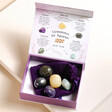 Aquarius Zodiac Gemstone Set open with gemstones inside on top of neutral coloured background