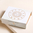 Capricorn Zodiac Gemstone Set inside of box on top of beige surface