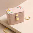 Embroidered Flowers Petite Travel Ring Box on Beige Surface