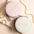 Personalised Rose Gold Script Name Mini Round Travel Jewellery Case on Pink Surface Surrounded by Jewellery