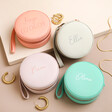 Personalised Mini Round Travel Jewellery Cases in pink grey lilac and blue on natural coloured background