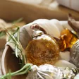 Amber Glass Bauble Nestled Amongst Other Baubles
