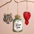 Tiger Beaded Hanging Decoration Hanging with Other Beaded Decorations Against Beige Surface