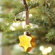 Gold Star Bauble Hanging in Christmas Tree