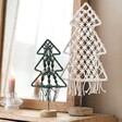 Green Woven Rope Tree Ornament with White Woven Rope Tree Ornament in Front of Mirror