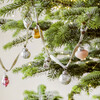 Mini Glass Bauble Garland Hanging Across Tree Branches