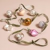 Mini Glass Bauble Garland on Pink Surface