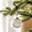 Silver Ribbed Glass Bauble hanging on Christmas Tree Branch 