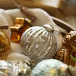 Silver Ribbed Glass Bauble Nestled Amongst Other Baubles