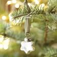 Tiny Silver Star Bauble Hanging from Christmas Tree