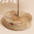 Close Up of Wooden Base on White Woven Rope Tree Ornament