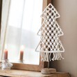 White Woven Rope Tree Ornament in Front of Mirror 
