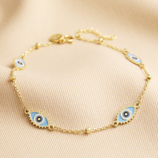 Blue Enamel Evil Eye Anklet in Gold on Beige Surface