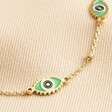 Close Up of Charms on Green Enamel Evil Eye Anklet in Gold