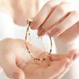 Model Holding Brown Double Layer Stone Beaded Bracelet in Gold