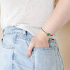 Model wearing Green Crystal and Stone Beaded Bracelet with hand in pocket