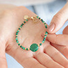 Model holding Green Crystal and Stone Beaded Bracelet in palm of hand