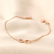 Infinity Charm Bracelet in Rose Gold on Beige Fabric