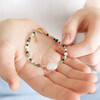 Model holding Multicoloured Crystal and Pearl Beaded Bracelet in palm of hand