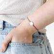 Model wearing Purple Crystal and Pearl Beaded Bracelet with hand in pocket