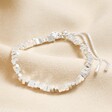 Rectangular Beaded Bracelet in Silver laid out on neutral coloured fabric