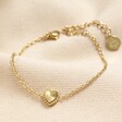 Stainless Steel Tiny Gold Heart Bracelet in Gold on Beige Fabric
