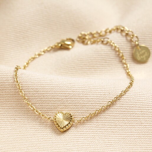 Stainless Steel Tiny Gold Heart Bracelet in Gold Stainless Steel Tiny Gold Heart Bracelet in Gold on Beige Fabric