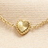 Close up of Charm on Stainless Steel Tiny Gold Heart Bracelet in Gold