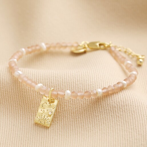 Talisman Charm Pink and Pearl Beaded Bracelet in Gold on Beige Fabric