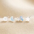 Set of Four Crystal Celestial Stud Earrings in Silver laid out on top of beige coloured background