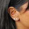 Close up of Set of Four Crystal Celestial Stud Earrings in Silver on model