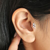 Close up of Titanium Crystal Fern Leaf Helix Earring on brunette model