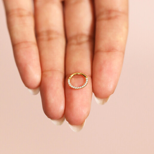 Model Holding Titanium Crystal Huggie Hoop in Gold