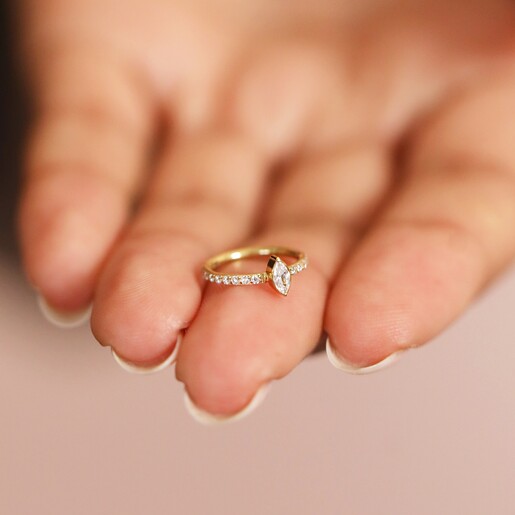 Model Holding Titanium Marquise Crystal Huggie Hoop Earring in Gold