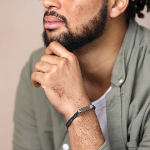Men's Leather Fishtail Bracelet in Grey on model with hand on chin