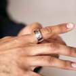 Close up of Men's Stainless Steel Textured Wide Band Ring on model in front of neutral coloured backdrop