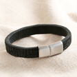 Men's Wide Woven Leather Bracelet in Black on top of beige coloured fabric