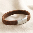 Men's Wide Woven Leather Bracelet in Brown on top of neutral coloured fabric
