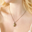 Antiqued Crystal Star Oval Locket Necklace in Gold on blonde model