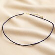Full Chain of Delicate Blue Stone Beaded Necklace on Beige Fabric