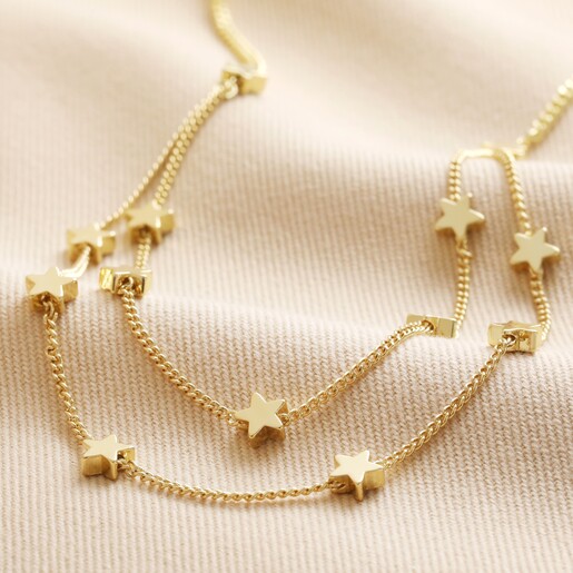 Double Chain and Star Charm Necklace in Gold on Beige Fabric