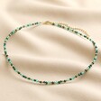 Gold Stainless Steel Stone Bead Necklace in Green full length on neutral coloured material